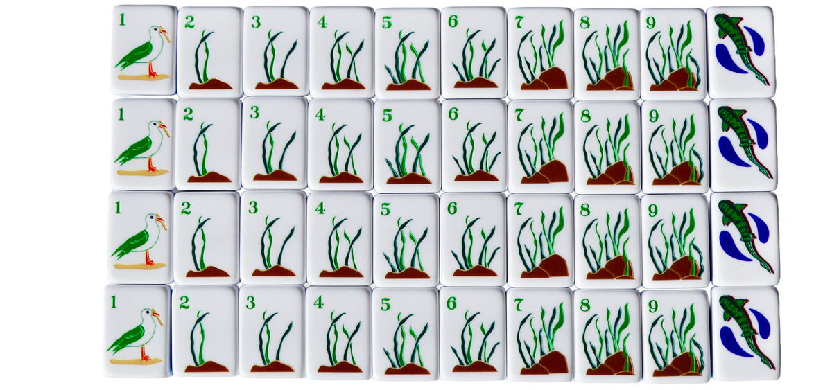 The La Jolla Tiles coastal mahjong set featuring sea kelp and seaweed as bams with a cheeky seagull with a French fry in its mouth. Beach sand La Jolla California mahjong Ivey Lee 